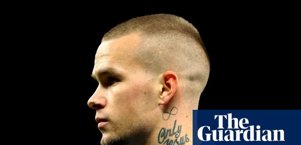 Player with short hair and neck tattoo profile