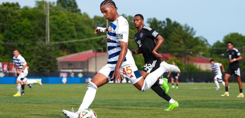 Player from Huntsville City kicking the ball