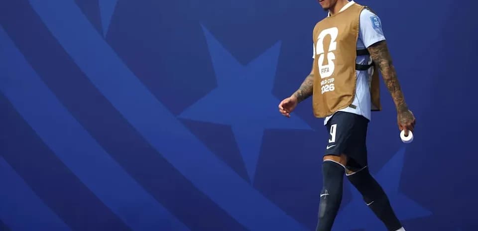 Player walking with training bib before match