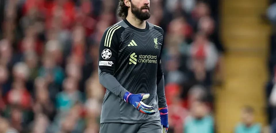 Goalkeeper in Liverpool kit walking on the pitch