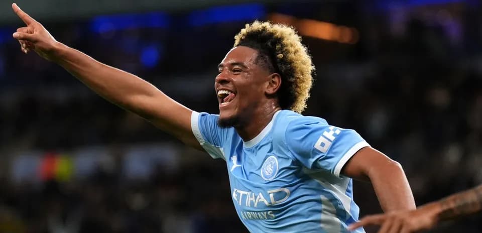 Player celebrating goal with raised hand in match