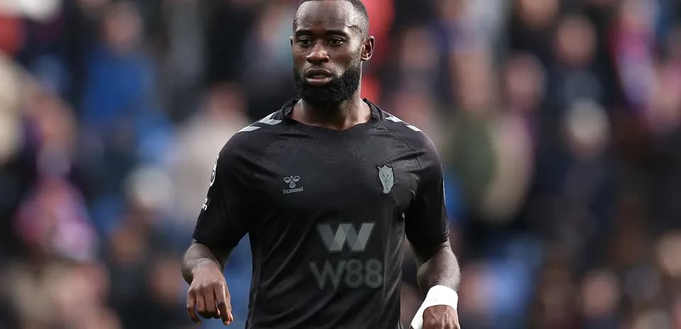 Player in black kit during match action