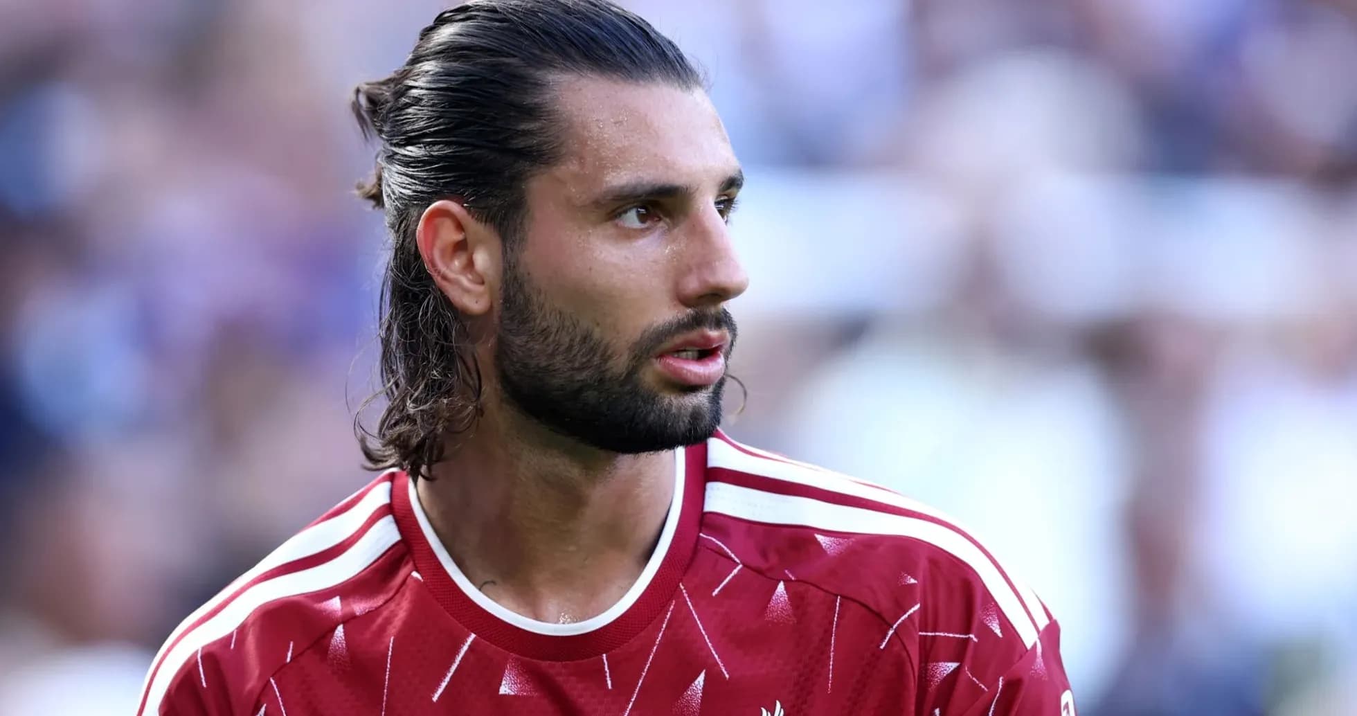 Player in Liverpool kit during match warm-up