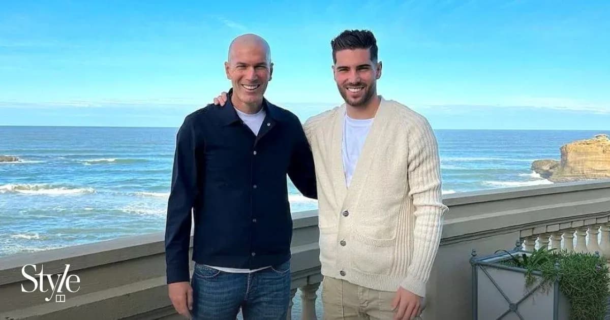 Two men posing together by the seaside