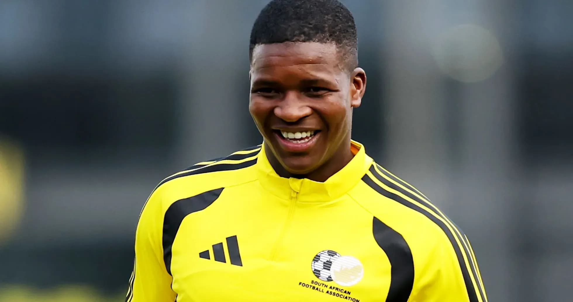 Player smiling in South African football training kit
