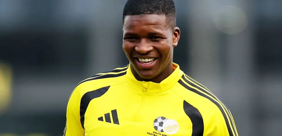 Player smiling in South African football training kit