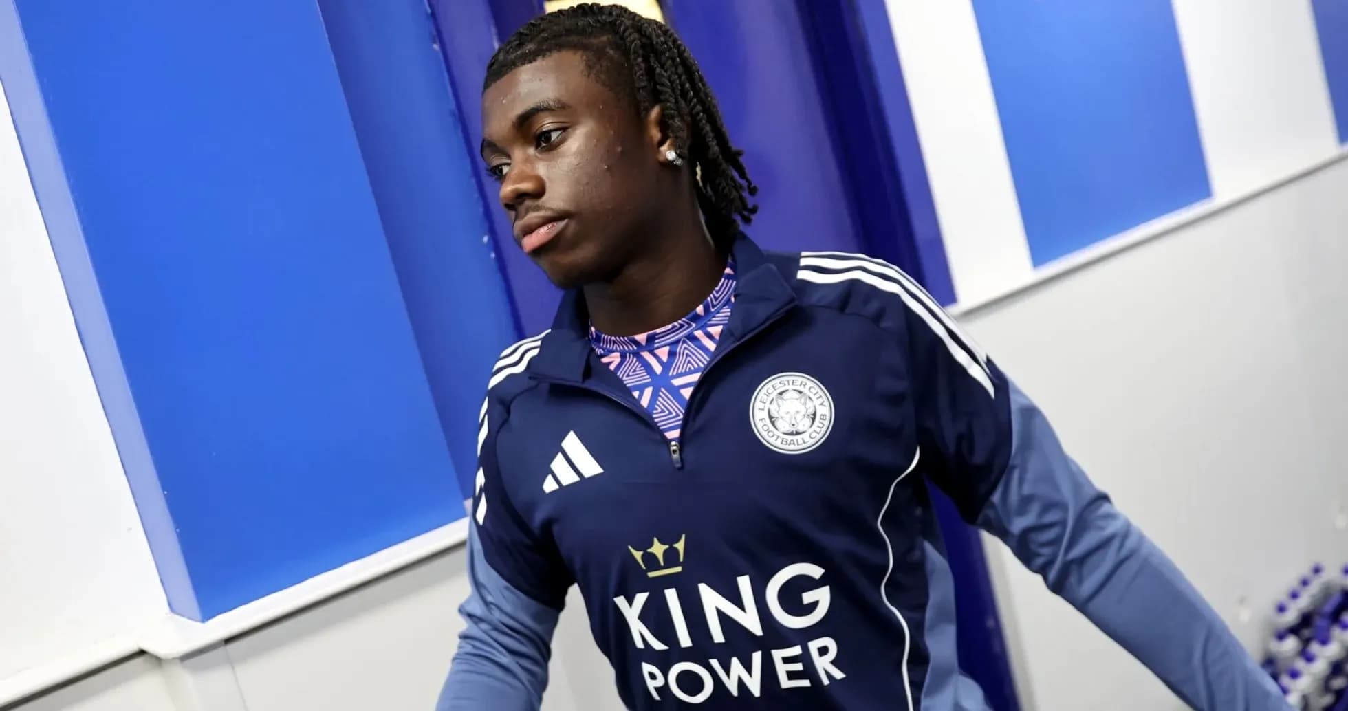 Player wearing Leicester City training kit in hallway