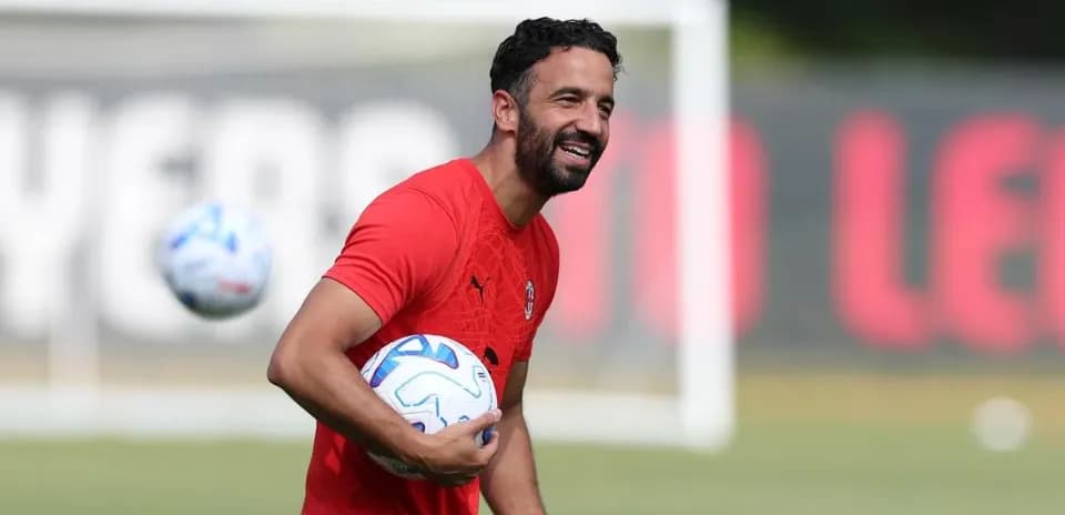 Coach holding a soccer ball during training session