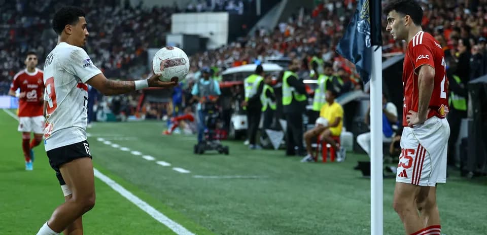 Player preparing to throw ball in football match