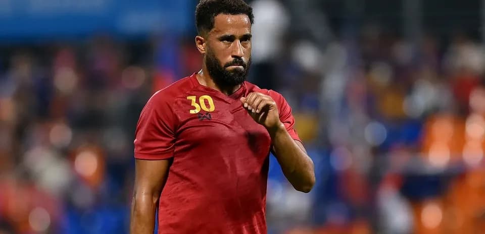 Player in red jersey gesturing during match