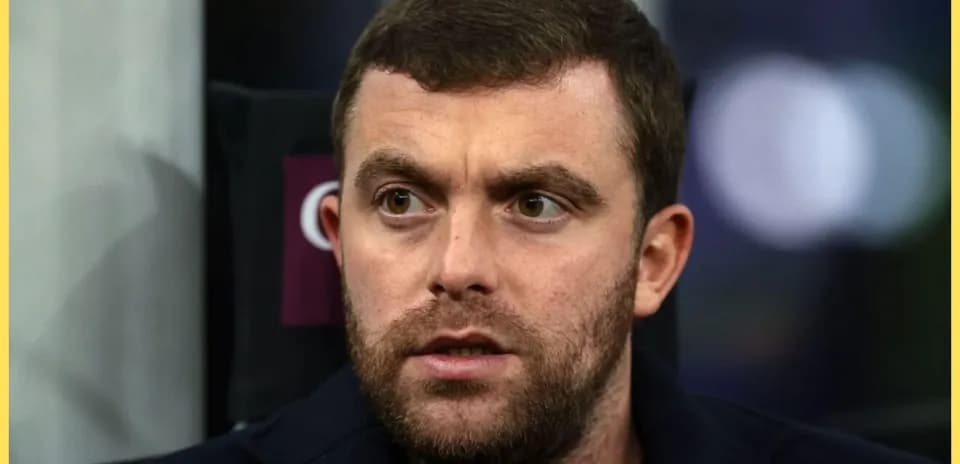 Close-up of a man with a beard in a dark jacket
