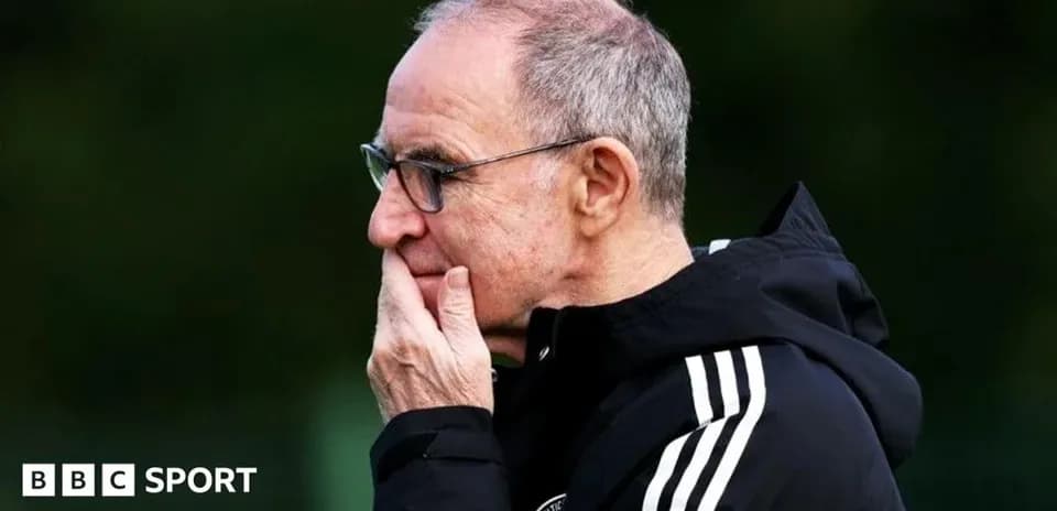 Coach observing training session with thoughtful expression
