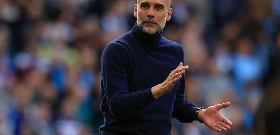 Coach gesturing during a football match on sidelines