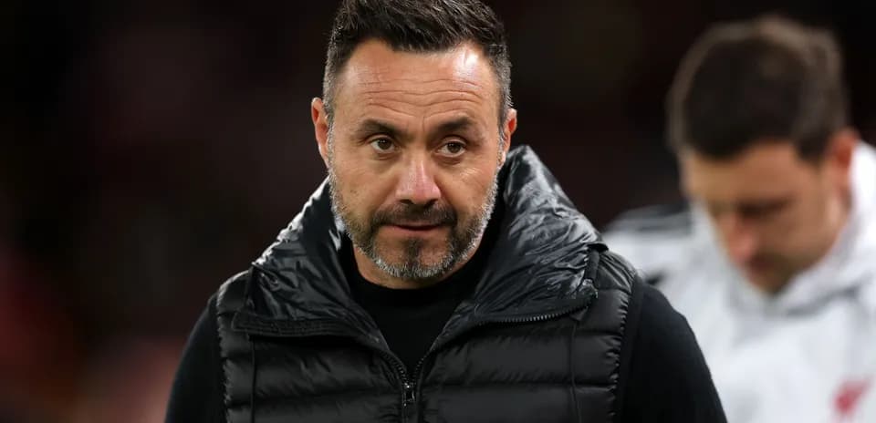 Coach in a puffer vest during match