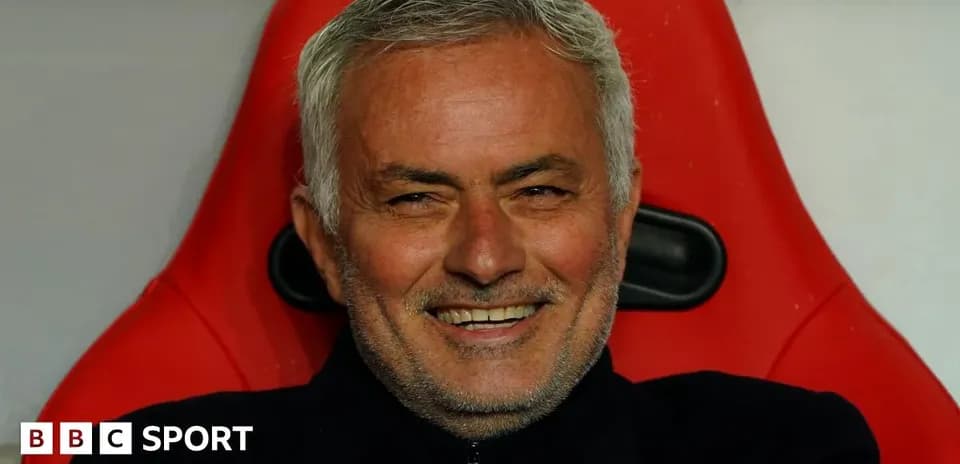 Coach sitting on bench with a smile