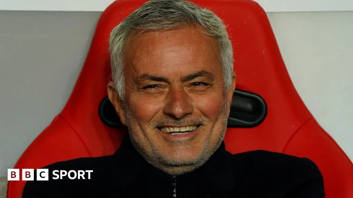 Coach sitting on bench with a smile