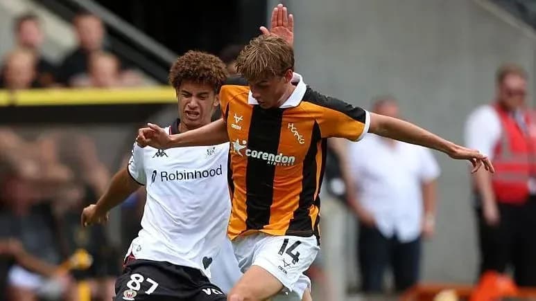 Two players challenging for the ball during match