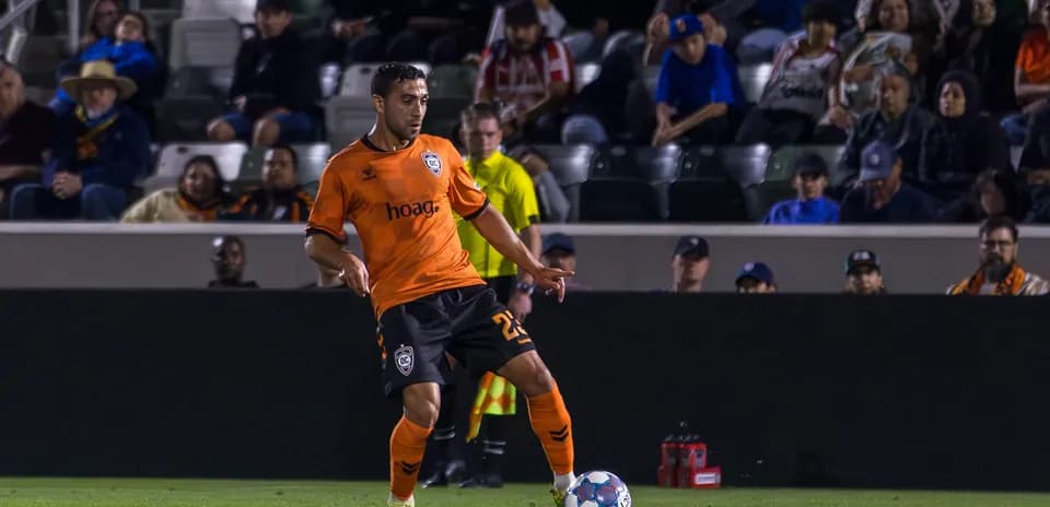 Player from Orange County SC with ball