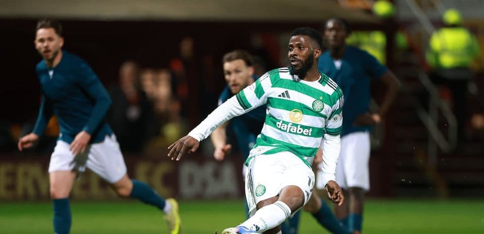 Celtic player dribbling ball during match action