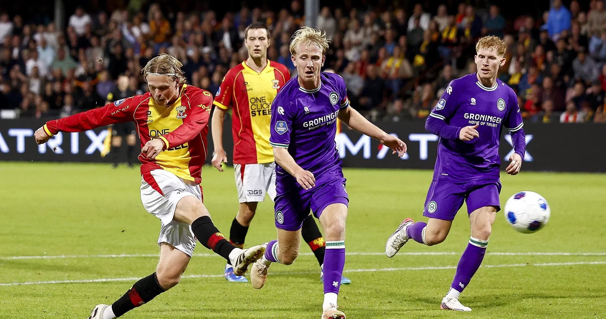 Player striking the ball during a football match
