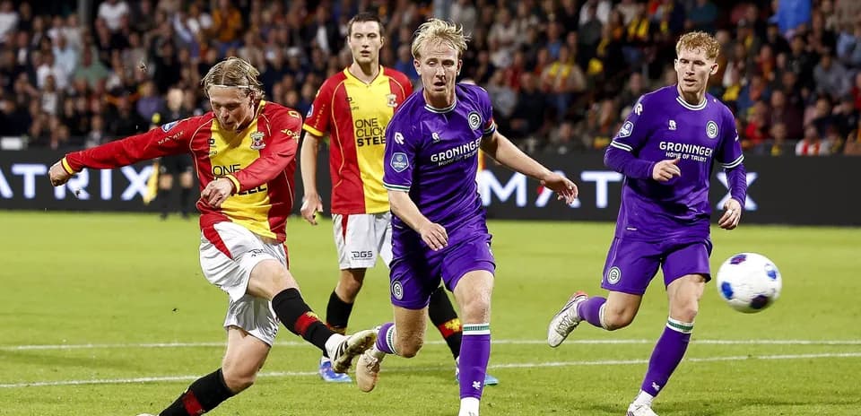 Player striking the ball during a football match
