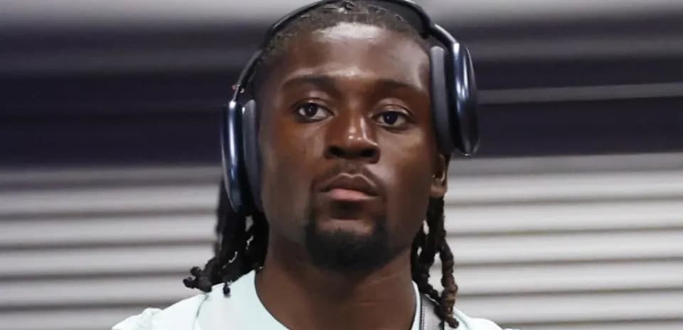 Athlete wearing headphones while walking indoors