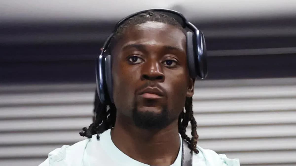 Athlete wearing headphones while walking indoors