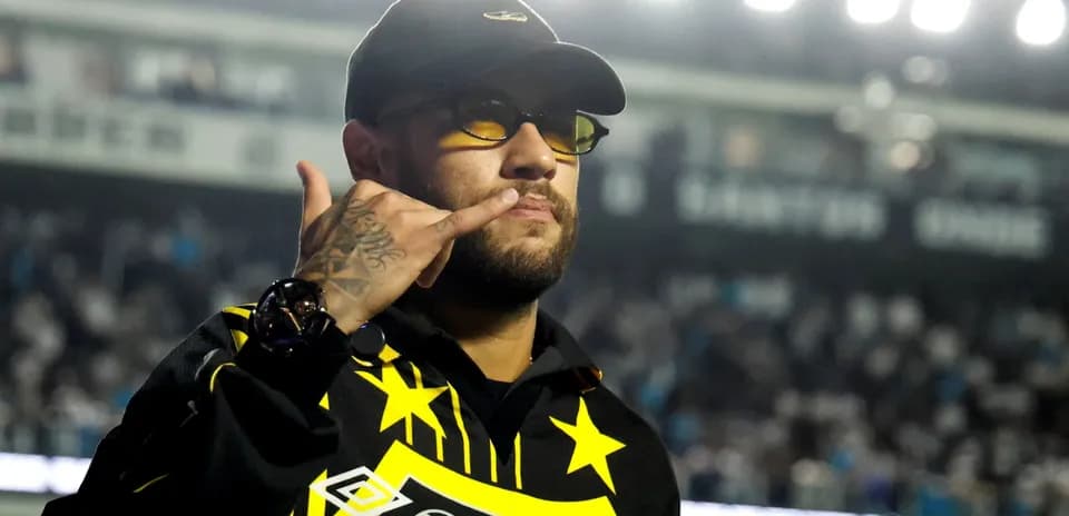 Man making phone gesture in sports venue