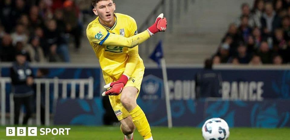 Goalkeeper throwing ball during a football match