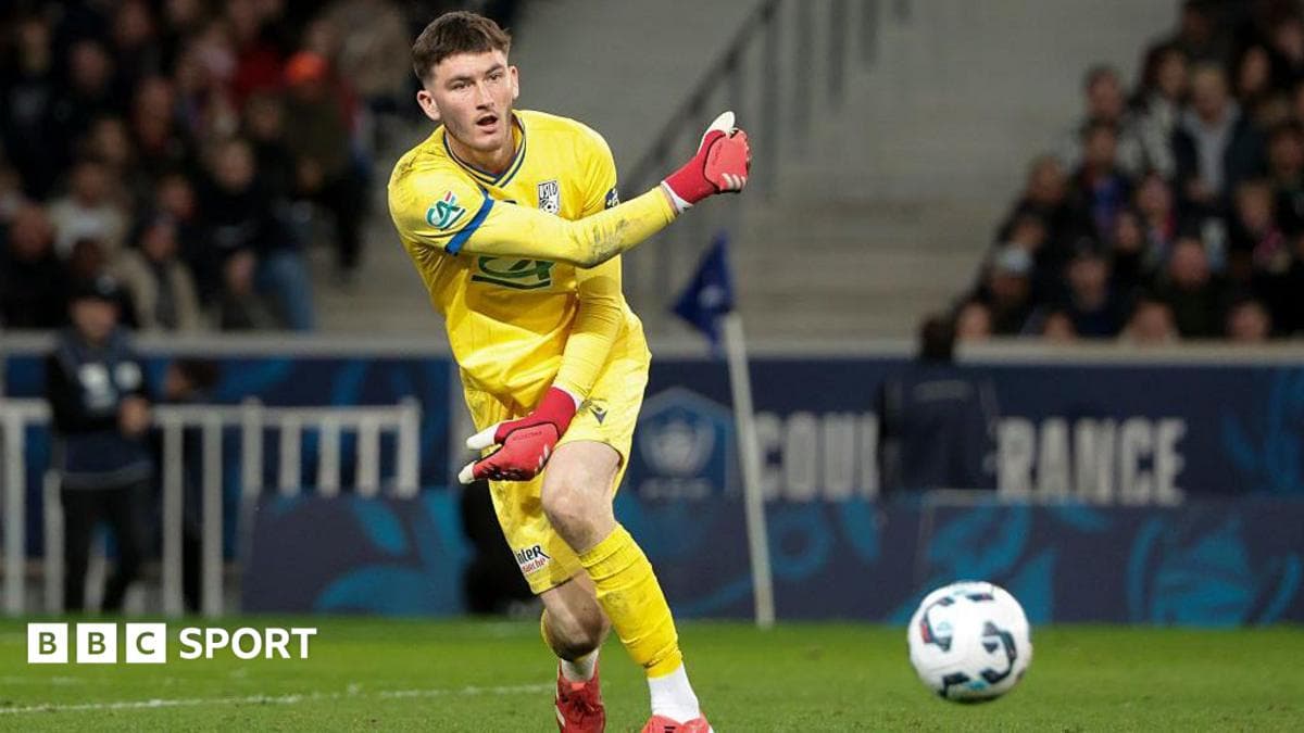 Goalkeeper throwing ball during a football match