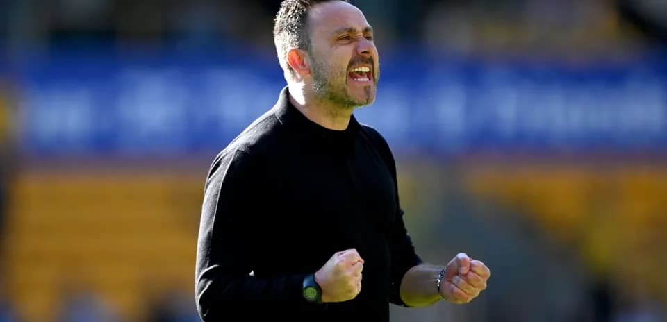 Coach celebrating passionately on the sidelines