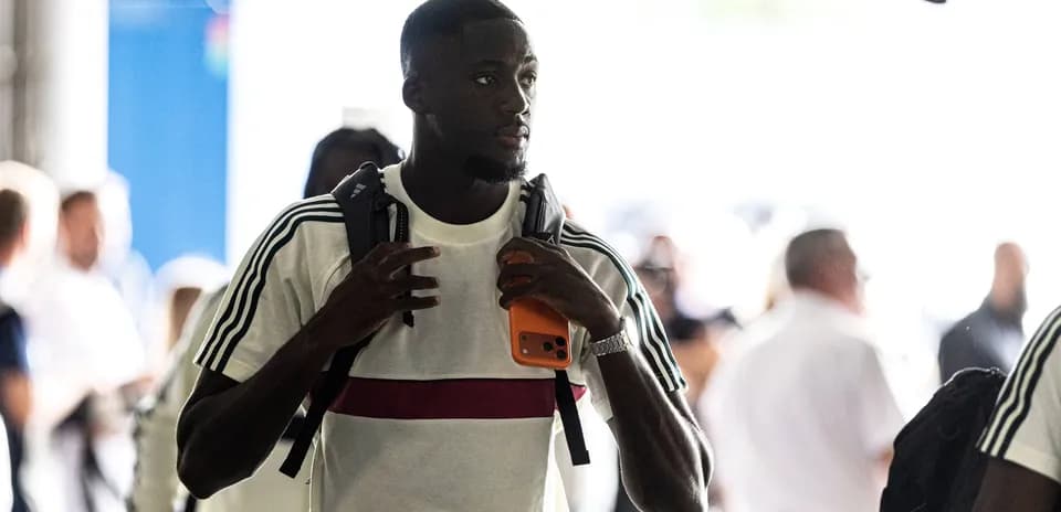 Player walking through entrance with backpack and phone