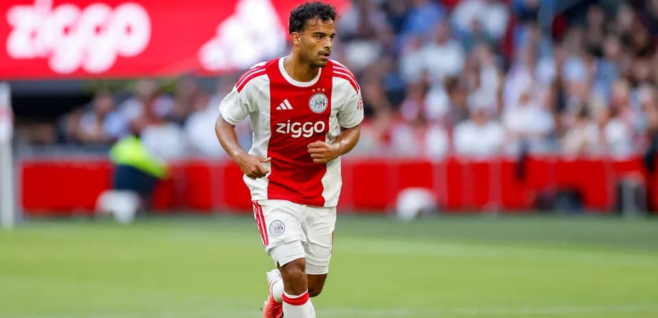 Player in Ajax kit running on the pitch
