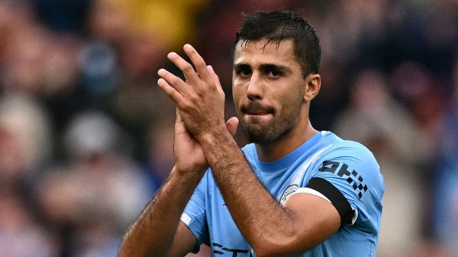 Player applauding fans after a match