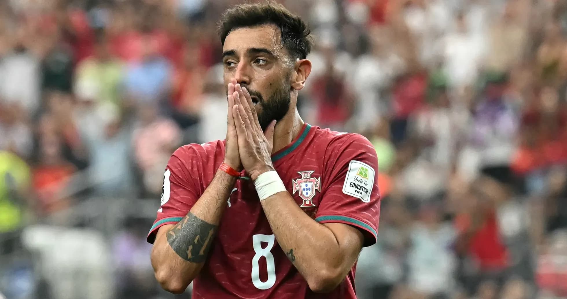 Player in Portugal jersey with hands on face