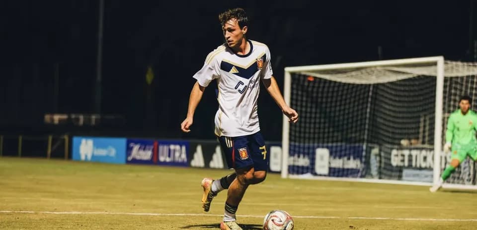 Player dribbling the ball during MLS Next Pro match