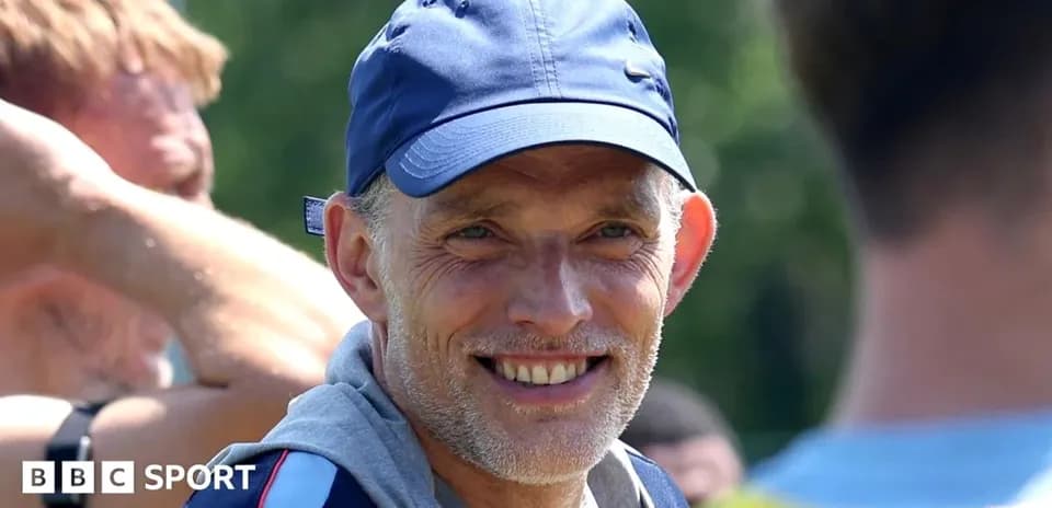 Coach smiling during training session with players