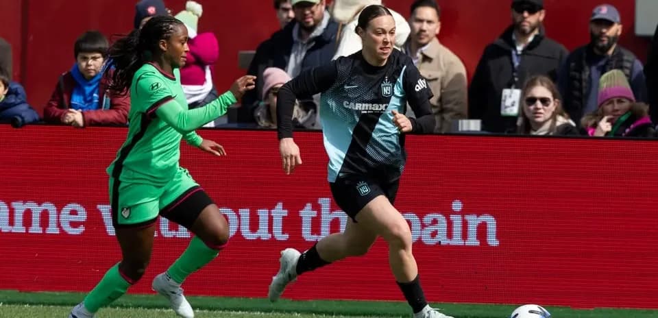 Player running with ball during NWSL match