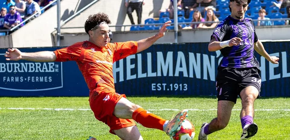 Player tackling during Forge vs Pacific FC match
