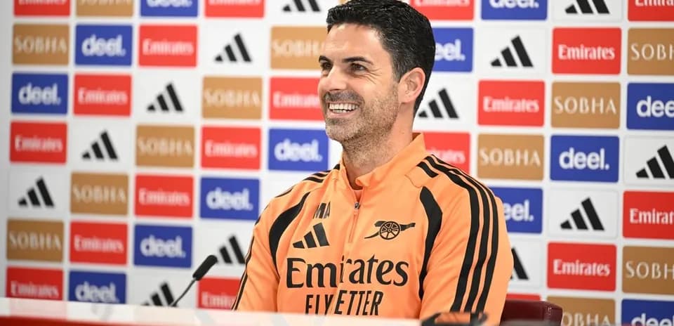 Manager at press conference with branded backdrop