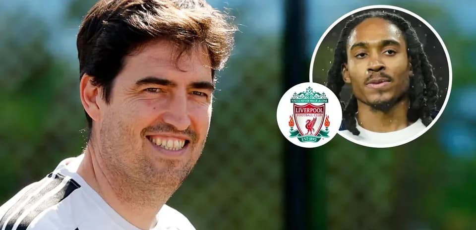 Coach smiling during training with Liverpool logo