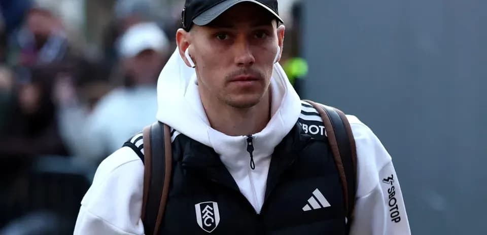 Player arriving at stadium wearing team jacket
