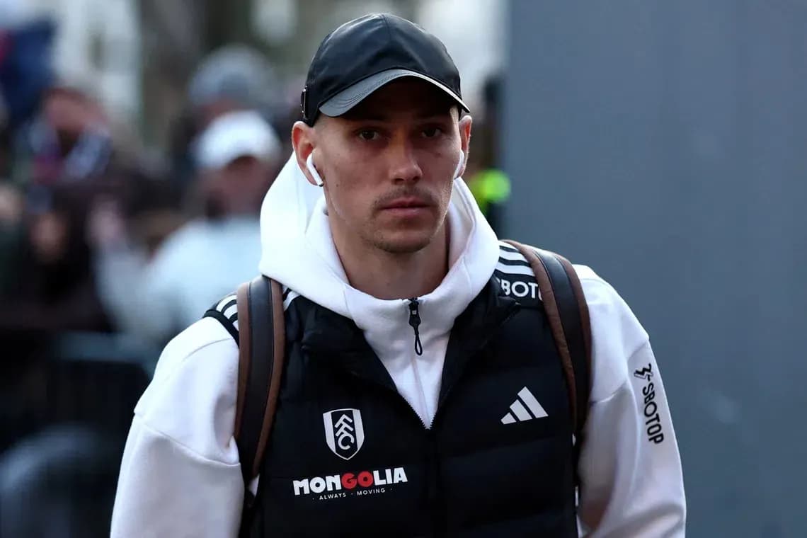 Player arriving at stadium wearing team jacket