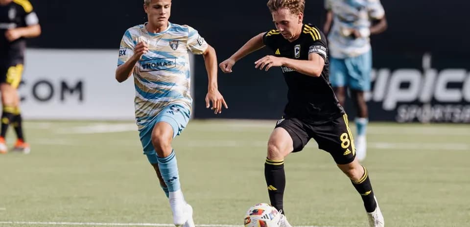 Columbus Crew II player dribbling past Philadelphia Union II opponent