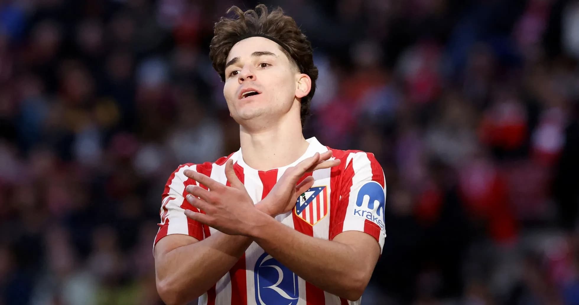 Atletico Madrid player gesturing on the pitch