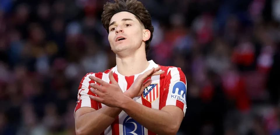 Atletico Madrid player gesturing on the pitch