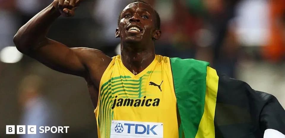 Athlete celebrating victory wearing Jamaican flag