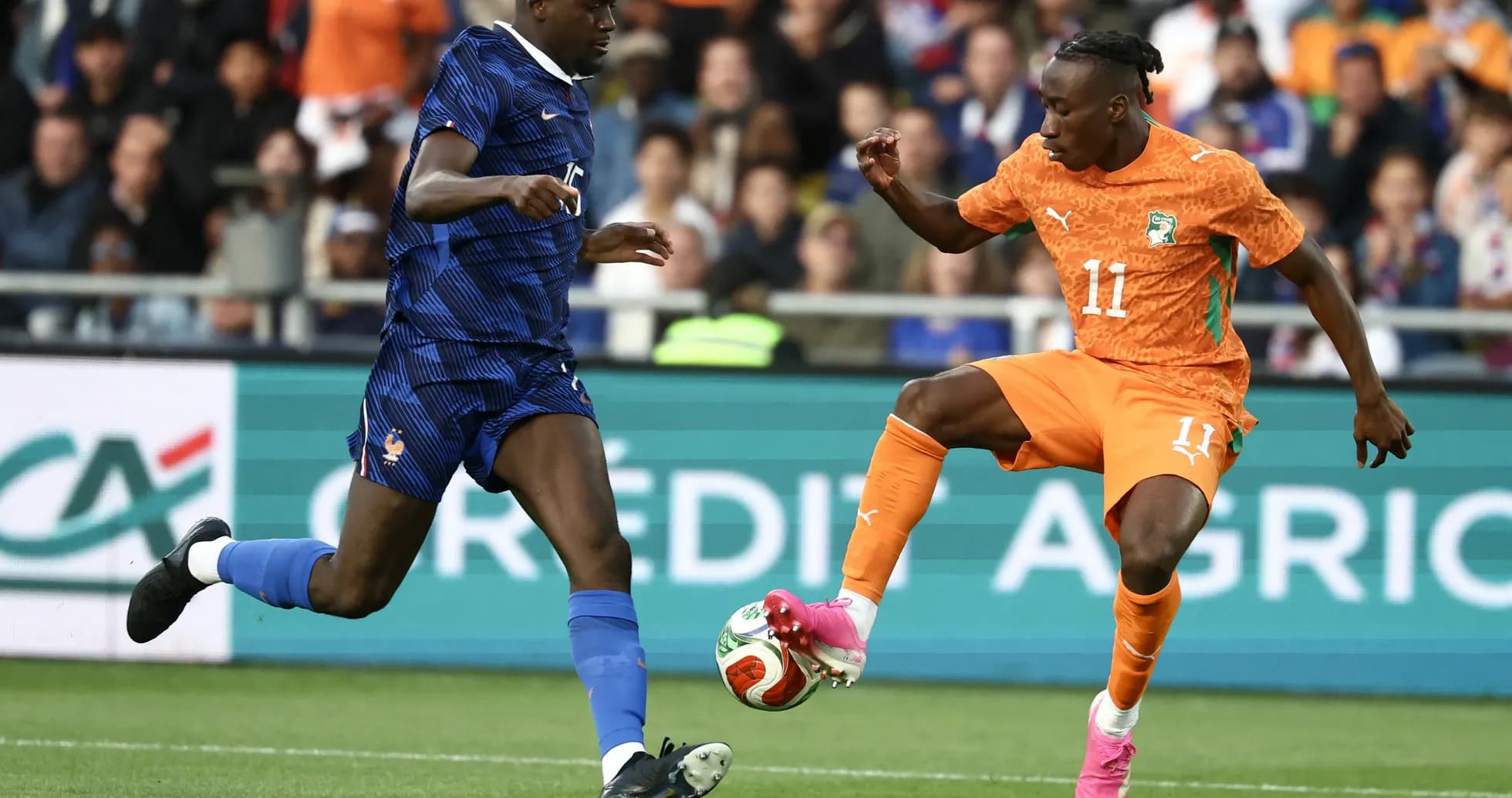 Player from France defending against Ivorian attacker