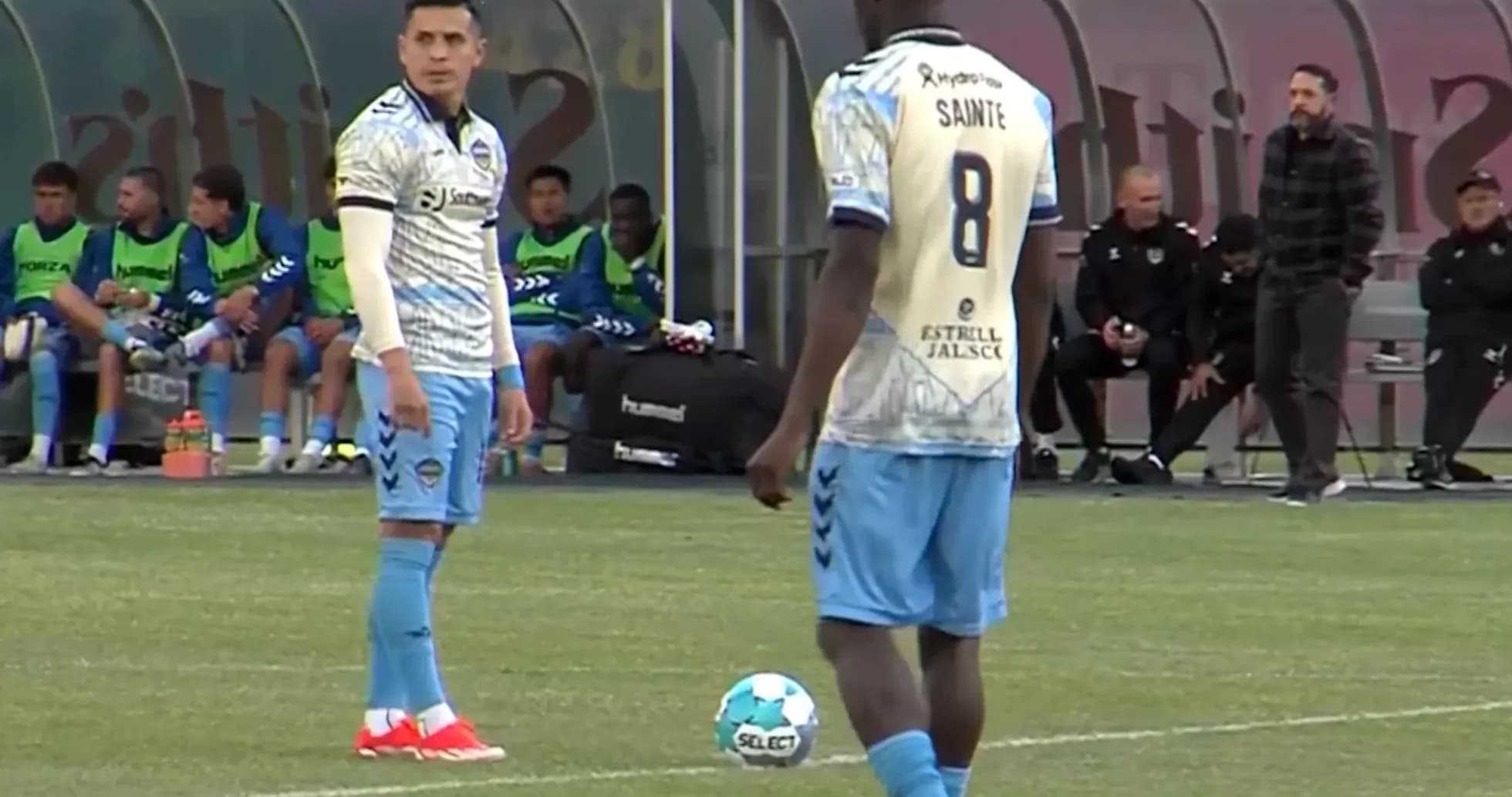 Players preparing for a free kick in match