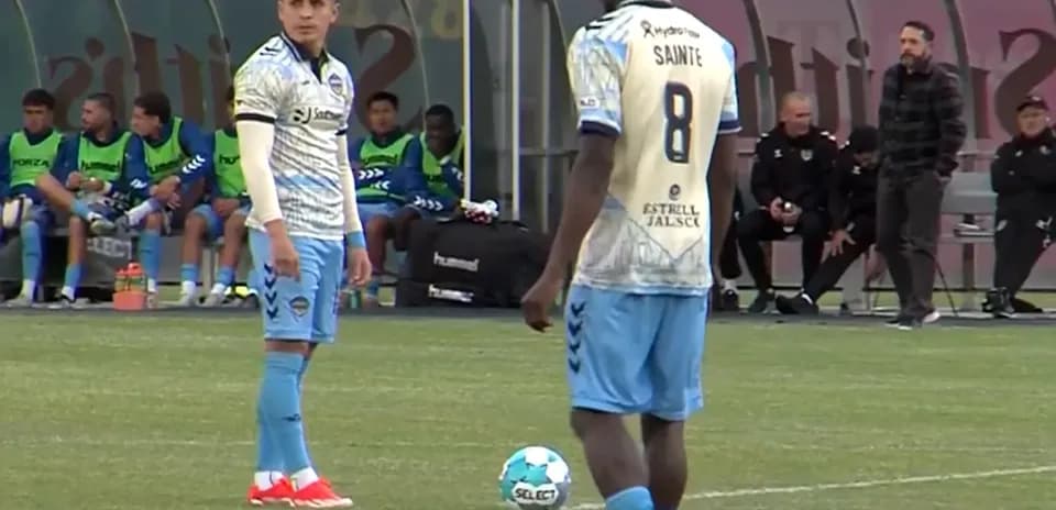 Players preparing for a free kick in match